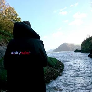 person wearing drytobe by the sea