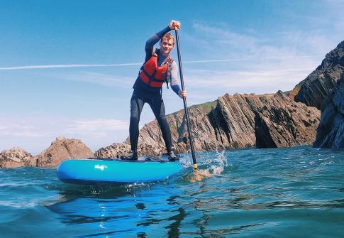 man paddleboarding around the north devon coast