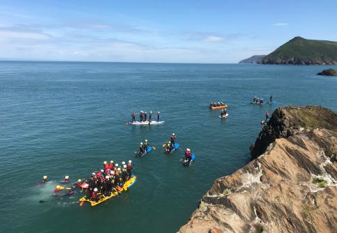 school group, residential, large groups, sea, stand up paddle board, coastline